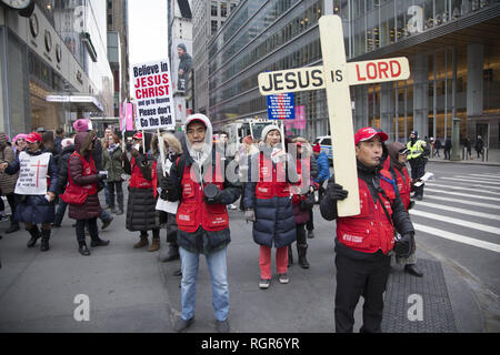 Fundamentalist Christian group of mostly Korean people march in  Manhattan encouraging people to take Jesus into their hearts so they don't go to Hell. Stock Photo