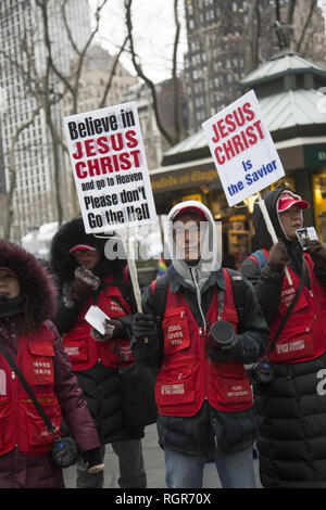 Fundamentalist Christian group of mostly Korean people march in  Manhattan encouraging people to take Jesus into their hearts so they don't go to Hell. Stock Photo