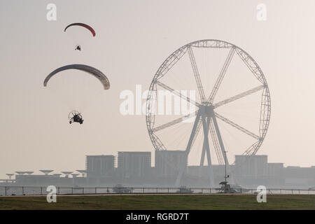 DUBAI, UAE - February 16, 2018:  Two parahubs with Dubai Eye and the huge Ferris Wheel in background at dusk, Dubai, UAE Stock Photo