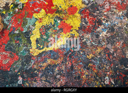 Spots of paint red, yellow, blue and other colors are randomly spilled on concrete and form an abstract background Stock Photo