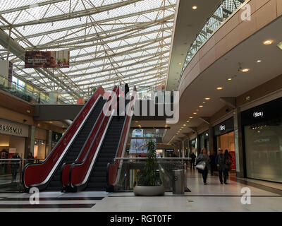 ATHENS, GREECE - JANUARY 17, 2019: Mall shopping centre with people walking and using the escalator. Stock Photo