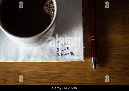 hand written note on a coffee stained napkin with an empowering message, I can I will I want to. Stock Photo