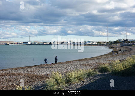 Fishermen at the beach on a sunny, cold, windy day in Río Grande, Tierra del Fuego Stock Photo