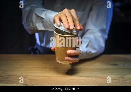 Barista serves coffee to the client. Hands Paper cup Bar counter Cappuccino Plastic cap. Coffee Business Concept Stock Photo