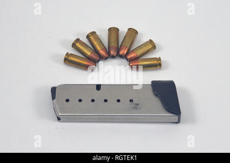 Pistol ammunition and magazine on white background. Used with semi-automatic pistol Stock Photo
