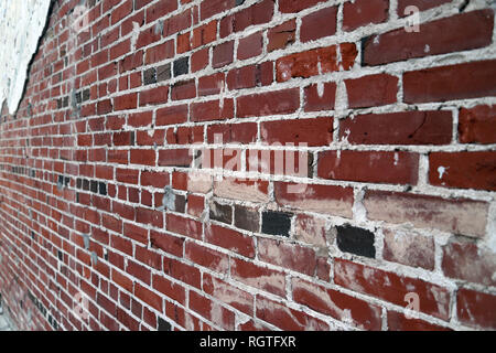Long view of Old painted Brick and mortar wall with plaster and pealing paint, background texture Stock Photo