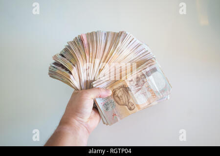 one hundred thai baht banknote with 5 baht and 1 baht coins stock photo