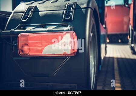 Automotive and Transportation Industry. New Semi Trucks For Sale. Rear View. Cargo Vehicles Dealership. Stock Photo