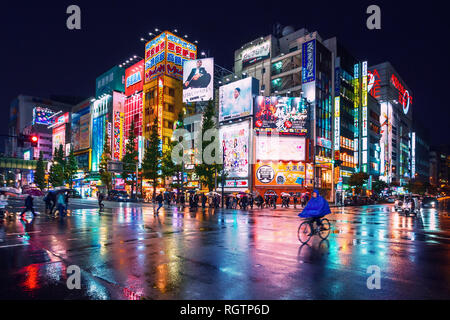 Neon lights and billboard advertisements on buildings at Akihabara at rainy night, Tokyo, Japan Stock Photo