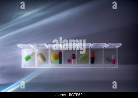 weekly pillbox with medication, conceptual image, horizontal composition Stock Photo