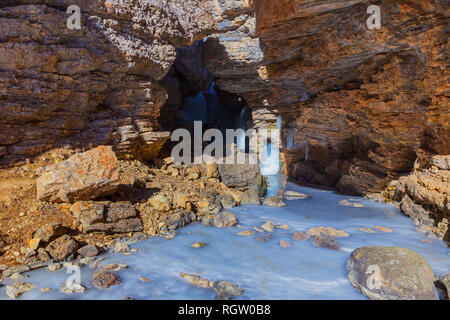 Frozen waterfall in a gorge high in the mountains Stock Photo