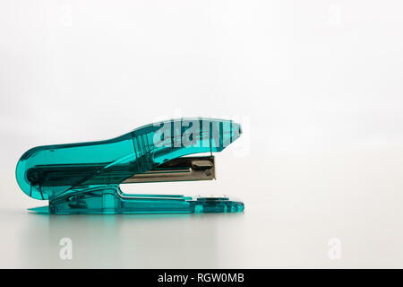 aqua colored Transparent Stapler. isolated with a white background. copy space available Stock Photo