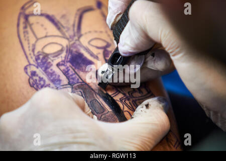 ALICANTE TATTOO FAIR CIRCA 2018 closeup tattoo artist working with gloves Stock Photo
