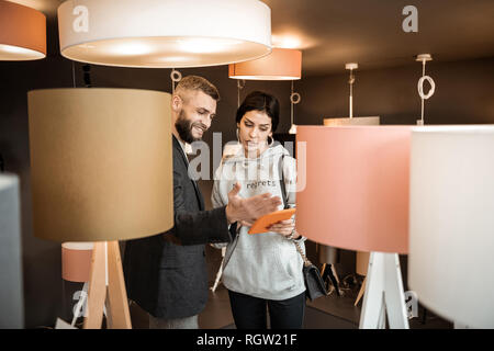 Curious couple having interesting conversation about appearance of their home Stock Photo