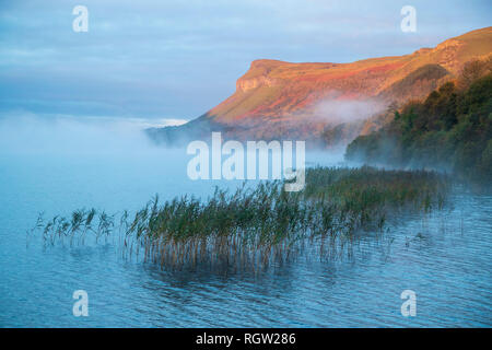 Dawn mist over Glencar Lake and Kings Mountain. County Sligo, Ireland. Stock Photo