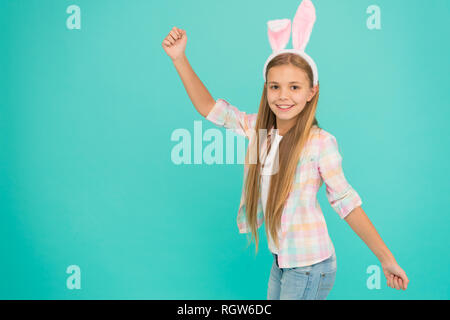 No easter party is complete without easter bunny. Fashion accessory for easter party. Small girl child in easter bunny style. Cute little girl wearing bunny ears headband. Looking pretty and adorable. Stock Photo