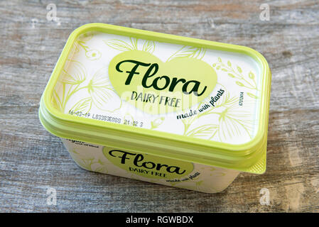 Flora dairy free vegan margarine in tub on wooden tray. Stock Photo