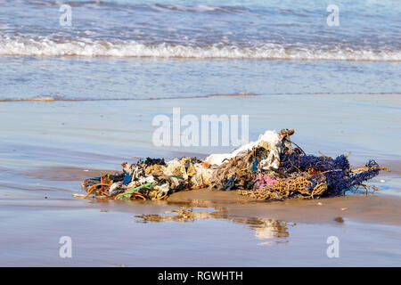 Rubbish, clothing and household belongings washed up from the Atlantic Ocean on Agadir beach, Morocco, Africa