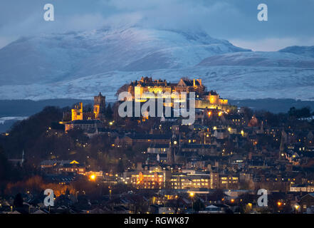 Stirling Castle and town of Stirling at dusk with the snow covered mountain (Stuc a Chroin ) in distance Stock Photo