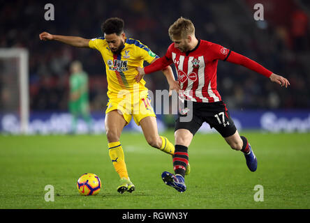 Crystal Palace's Andros Townsend (left) and Southampton's Stuart Armstrong battle for the ball during the Premier League match at St Mary's Stadium. Stock Photo