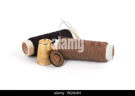 thread, needle, button and thimble on isolate white  background Stock Photo