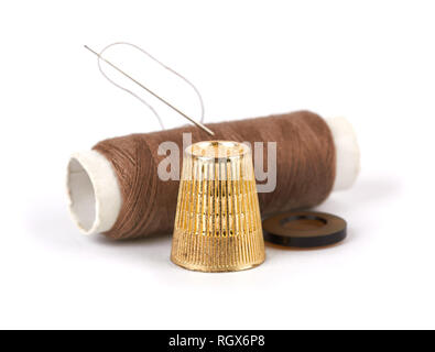 thread, needle, button and thimble on isolate white background Stock Photo