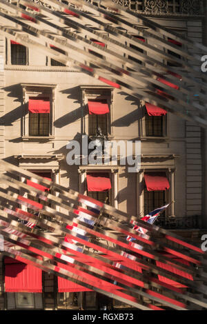 Cartier Mansion on Fifth Avenue is seen through the Diagonally-rippled glass window of the Nike Flagship store, New York City, USA Stock Photo