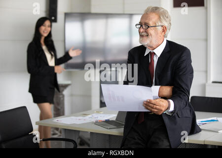 businessmen holding documents for business partners discussing  and share ideas at meeting and business women smiling happy for working Stock Photo