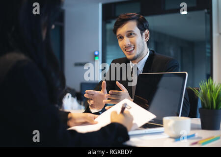 Businessmen and Businesswomen discussing documents for job interview concept Stock Photo