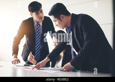 businessmen working and point on graph financial diagram and analysis documents on office table Stock Photo