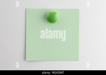 Square blank sheet of green paper pinned with a button magnet on white refrigerator Stock Photo