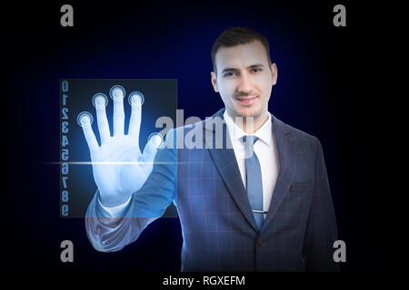 Smiling man wearing suit and tie touching transparent screen with fingers for recognition as futuristic concept on blue background Stock Photo
