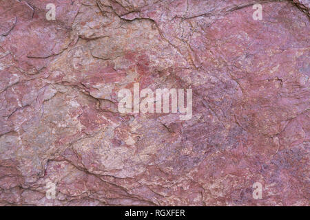 Stone texture background with unique pattern. Pink rock texture. Rock surface abstract background. Natural stone background. Purple rough stone floor. Stock Photo
