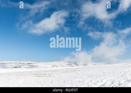 Winter landscape, clouds on the slope of a snowy mountain Stock Photo