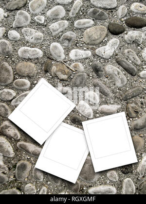 Three blank square instant photo frames on pebble background Stock Photo