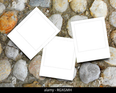 Three blank square instant photo frames on brown pebble background Stock Photo