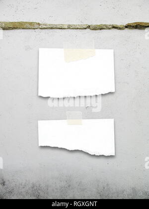 Two ripped pieces of paper frames on gray concrete wall background Stock Photo