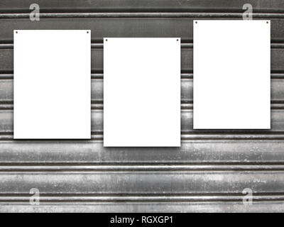 Three nailed blank frames on gray rusty metal shutter background Stock Photo