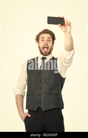 Businessman with phone in outfit isolated on white background. Buy online and digital marketing. Guy presenting product of smartphone. Business and communication. happy man with mobile or cell phone. Stock Photo