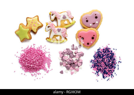 Unicorn and heart shaped sugar cookies decorated with pastel royal icing on white background. Fairy tales concept. Top view. Stock Photo