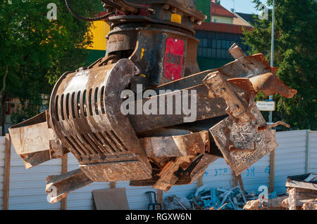 Demolition site. Sorting Grabs used to sort waste. Here recovery of iron girder. Stock Photo