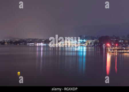 Cityscape at Night with Lake Zurich and Mountain in Switzerland. Stock Photo