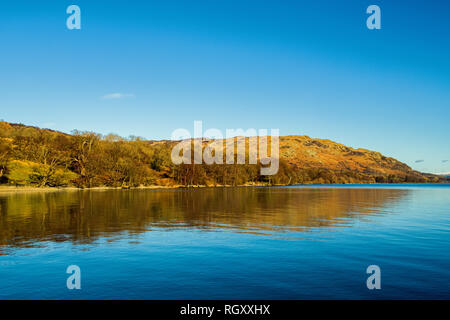 Ullswater seen from the road to Pooley Bridge Lake District National Park on a bright, blue sky, sunny day in Cumbria. Stock Photo