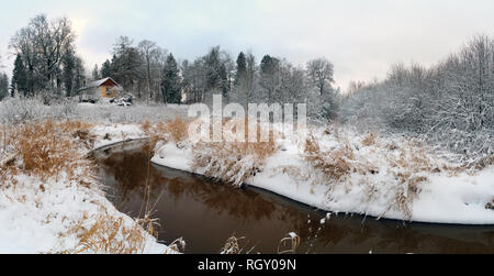 The first snow on the Bank of the Lubya river .Winter landscape. Russia, Leningrad region. Priyutino. Stock Photo