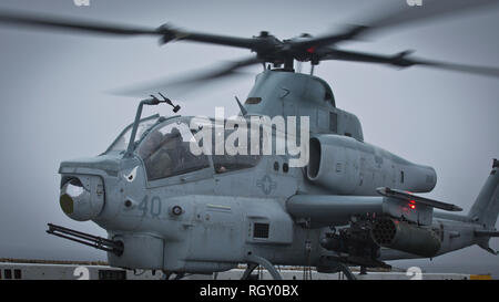 190116-M-QS181-0180 PACIFIC OCEAN (Jan. 16, 2019) Pilots with Marine Medium Tiltrotor Squadron 163 (Reinforced), 11th Marine Expeditionary Unit (MEU), prepare to take off in an AH-1W Super Cobra from the San Antonio-class amphibious transport dock ship USS John P. Murtha (LPD 26) during flight operations.  The Marines and Sailors of the 11th MEU are conducting routine operations as a part of USS Boxer Amphibious Ready Group (ARG) in the eastern Pacific Ocean. (U.S Marine Corps photo by Lance Cpl. Jason Monty) Stock Photo