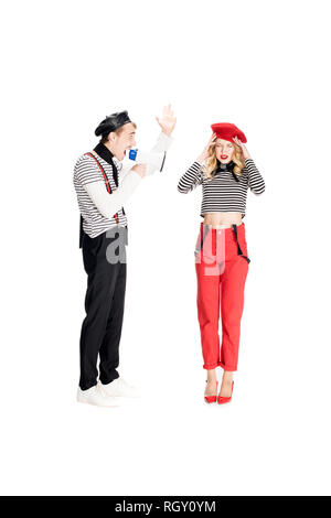 angry man yelling in megaphone on attractive woman isolated on white Stock Photo