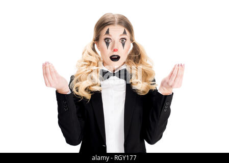 surprised female clown standing in suit and gesturing isolated on white Stock Photo