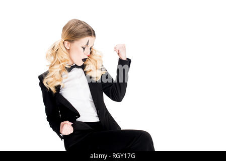 blonde female clown standing in suit and showing muscles isolated on white Stock Photo