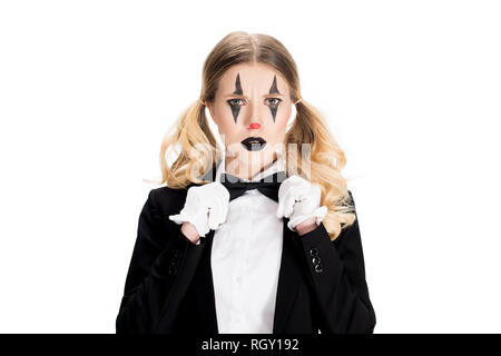 sad female clown standing in suit and touching bow tie isolated on white Stock Photo