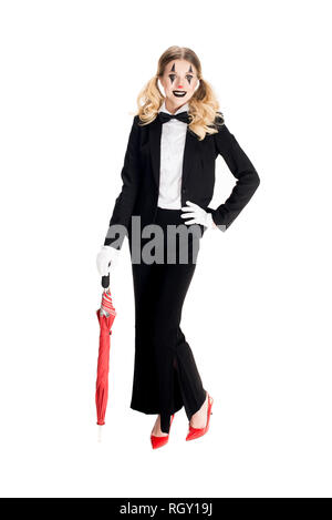 happy female clown holding umbrella while standing in suit isolated on white Stock Photo